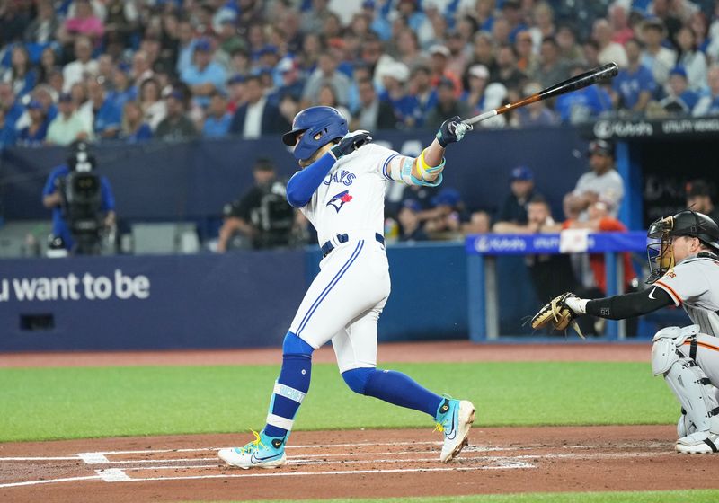 Jun 28, 2023; Toronto, Ontario, CAN; Toronto Blue Jays shortstop Bo Bichette (11) hits an RBI single against the San Francisco Giants during the first inning at Rogers Centre. Mandatory Credit: Nick Turchiaro-USA TODAY Sports