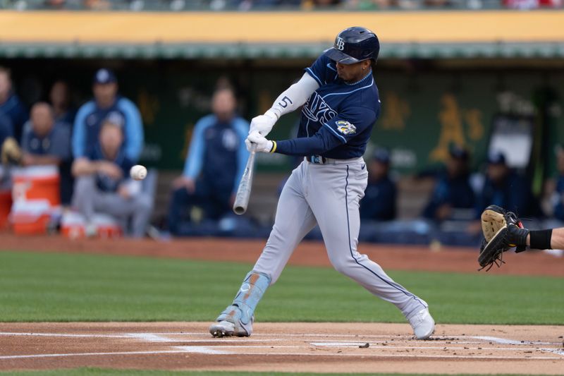 Jun 14, 2023; Oakland, California, USA;  Tampa Bay Rays shortstop Wander Franco (5) hits a double against the Oakland Athletics during the first inning at Oakland-Alameda County Coliseum. Mandatory Credit: Stan Szeto-USA TODAY Sports