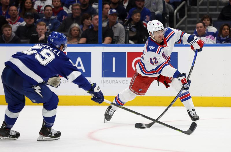 Nov 12, 2025; Tampa, Florida, USA; New York Rangers center Noah Laba (42) passes the puck as Tampa Bay Lightning center Jake Guentzel (59) defends during the second period at Benchmark International Arena. Mandatory Credit: Kim Klement Neitzel-Imagn Images