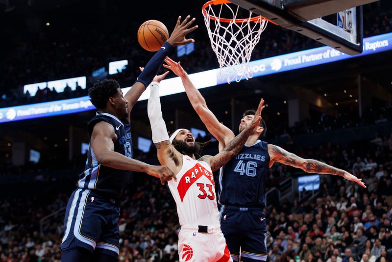 TORONTO, CANADA - JANUARY 22: Gary Trent Jr. #33 of the Toronto Raptors puts up a shot against Jaren Jackson Jr. #13 and John Konchar #46 of the Memphis Grizzlies in the first half at Scotiabank Arena on January 22, 2024 in Toronto, Canada. NOTE TO USER: User expressly acknowledges and agrees that, by downloading and or using this photograph, User is consenting to the terms and conditions of the Getty Images License Agreement. (Photo by Cole Burston/Getty Images)