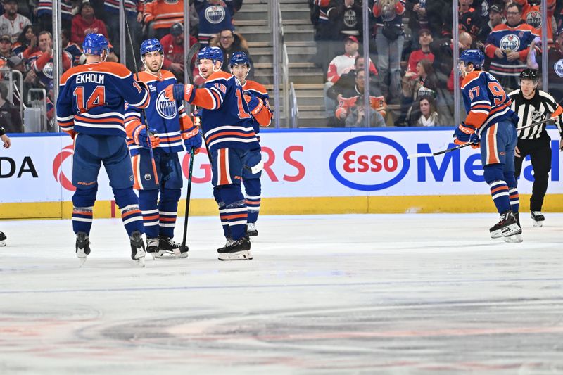 Dec 11, 2025; Edmonton, Alberta, CAN; Edmonton Oilers defenseman Mattias Ekholm (14), defenseman Evan Bouchard (2) and left winger Zach Hyman (18) celebrate a goal on Detroit Red Wings goalie Cam Talbot (39) during the second period at Rogers Place. Mandatory Credit: Walter Tychnowicz-Imagn Images