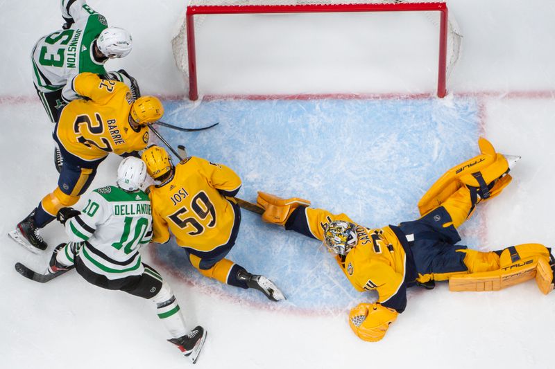 Feb 15, 2024; Nashville, Tennessee, USA; Nashville Predators goaltender Juuse Saros (74) blocks the shot of Dallas Stars center Wyatt Johnston (53) during the first period at Bridgestone Arena. Mandatory Credit: Steve Roberts-USA TODAY Sports