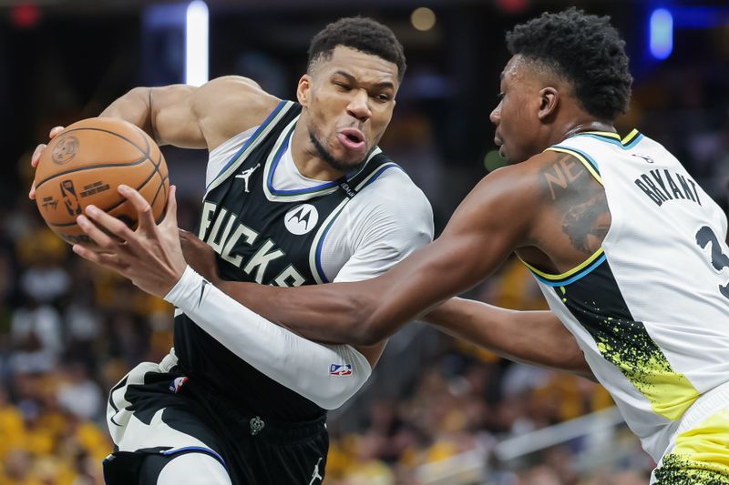 INDIANAPOLIS, INDIANA - APRIL 19: Giannis Antetokounmpo #34 of the Milwaukee Bucks drives to the basket drives to the basket against Thomas Bryant #3 of the Indiana Pacers during the fourth quarter in game one of the NBA playoffs at Gainbridge Fieldhouse on April 19, 2025 in Indianapolis, Indiana. NOTE TO USER: User expressly acknowledges and agrees that, by downloading and or using this photograph, User is consenting to the terms and conditions of the Getty Images License Agreement. (Photo by Michael Hickey/Getty Images)