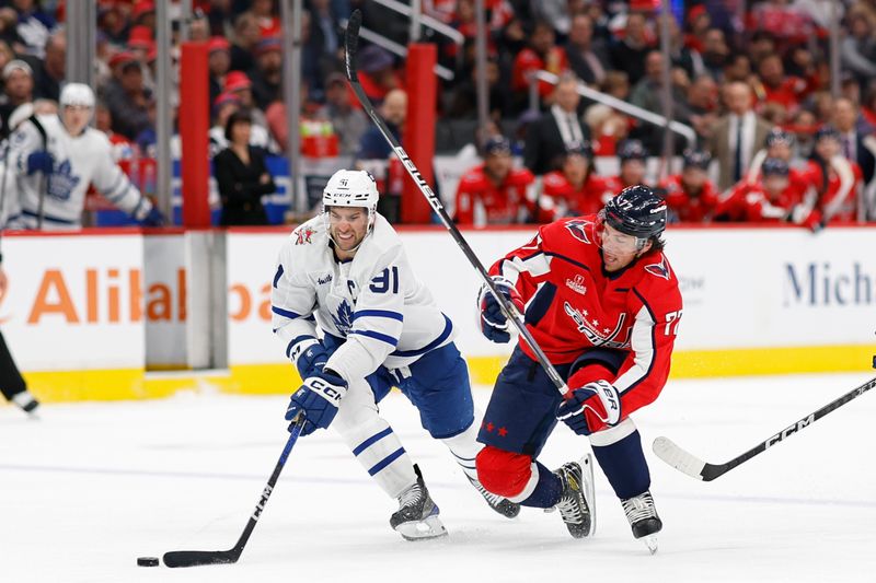 Oct 24, 2023; Washington, District of Columbia, USA; Toronto Maple Leafs center John Tavares (91) and Washington Capitals right wing T.J. Oshie (77) battle for the puck in the third period at Capital One Arena. Mandatory Credit: Geoff Burke-USA TODAY Sports