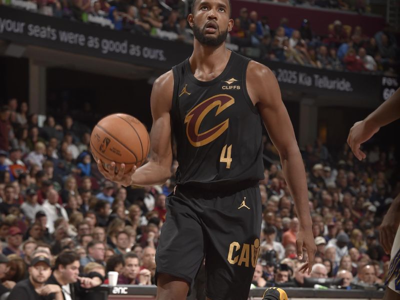 CLEVELAND, OH - NOVEMBER 8: Evan Mobley #4 of the Cleveland Cavaliers drives to the basket during the game against the Golden State Warriors during a regular season game on November 8, 2024 at Rocket Mortgage FieldHouse in Cleveland, Ohio. NOTE TO USER: User expressly acknowledges and agrees that, by downloading and/or using this Photograph, user is consenting to the terms and conditions of the Getty Images License Agreement. Mandatory Copyright Notice: Copyright 2024 NBAE (Photo by David Liam Kyle/NBAE via Getty Images)