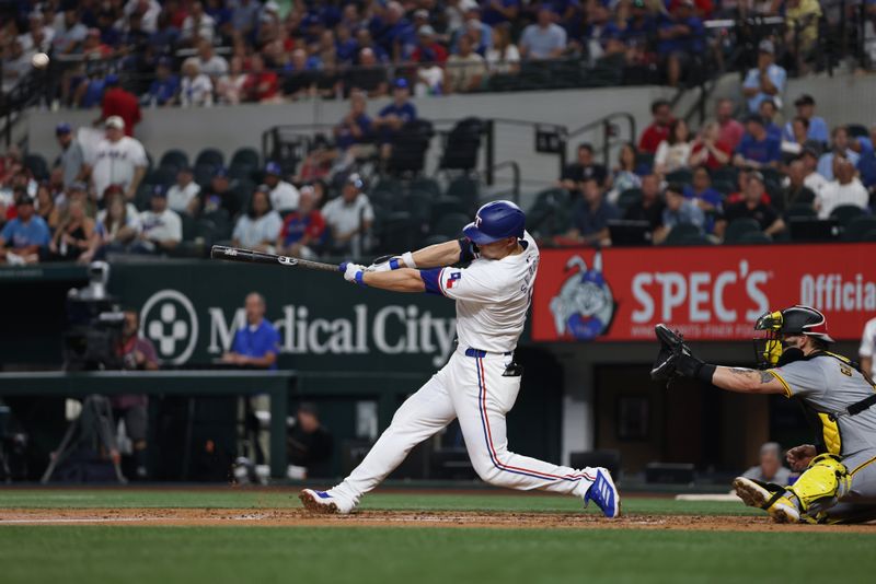 Aug 19, 2024; Arlington, Texas, USA; Texas Rangers shortstop Corey Seager (5) hits a three-run home run against the Pittsburgh Pirates in the third inning at Globe Life Field. Mandatory Credit: Tim Heitman-USA TODAY Sports