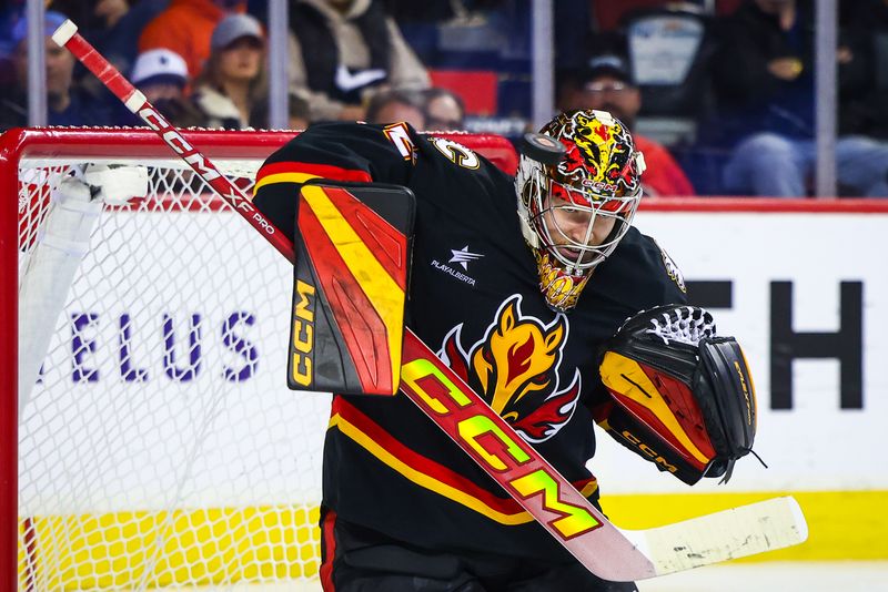 Oct 26, 2024; Calgary, Alberta, CAN; Calgary Flames goaltender Dustin Wolf (32) makes a save against the Winnipeg Jets during the third period at Scotiabank Saddledome. Mandatory Credit: Sergei Belski-Imagn Images