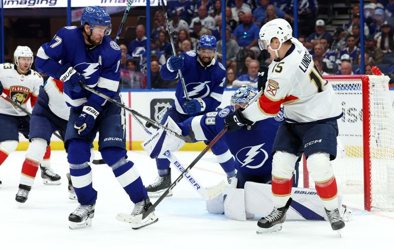 Apr 27, 2024; Tampa, Florida, USA; Tampa Bay Lightning goaltender Andrei Vasilevskiy (88) makes a save as defenseman Victor Hedman (77), left wing Anthony Duclair (10) and Florida Panthers center Anton Lundell (15) defend during the second period in game four of the first round of the 2024 Stanley Cup Playoffs at Amalie Arena. Mandatory Credit: Kim Klement Neitzel-USA TODAY Sports