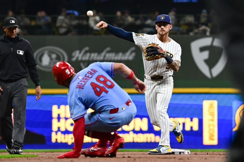 Sep 13, 2025; Milwaukee, Wisconsin, USA;  Milwaukee Brewers shortstop Joey Ortiz (3) completes a double play after forcing out St. Louis Cardinals designated hitter Ivan Herrera (48) in the third inning at American Family Field. Mandatory Credit: Benny Sieu-Imagn Images