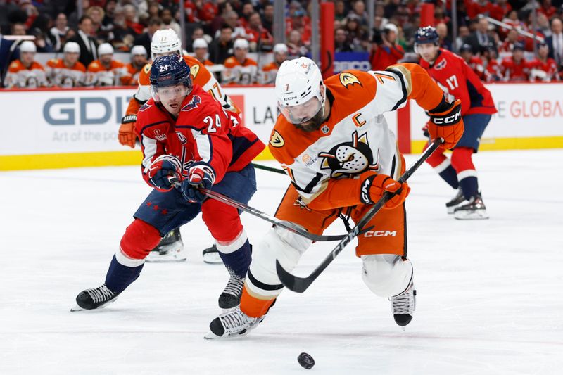 Jan 14, 2025; Washington, District of Columbia, USA; Anaheim Ducks defenseman Radko Gudas (7) skates with the puck as Washington Capitals center Connor McMichael (24) defends in the third period at Capital One Arena. Mandatory Credit: Geoff Burke-Imagn Images