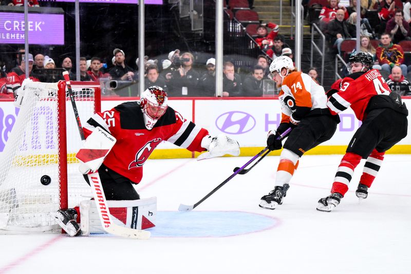 Nov 29, 2025; Newark, New Jersey, USA; New Jersey Devils goaltender Jacob Markstrom (25) makes a save against Philadelphia Flyers right wing Owen Tippett (74) during the third period at Prudential Center. Mandatory Credit: John Jones-Imagn Images