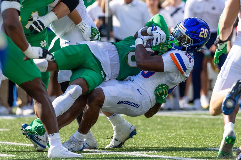 Oct 4, 2025; South Bend, Indiana, USA; Boise State Broncos running back Sire Gaines (26) gets tackled by Notre Dame Fighting Irish cornerback DeVonta Smith (0) during the first half at Notre Dame Stadium. Mandatory Credit: Michael Caterina-Imagn Images