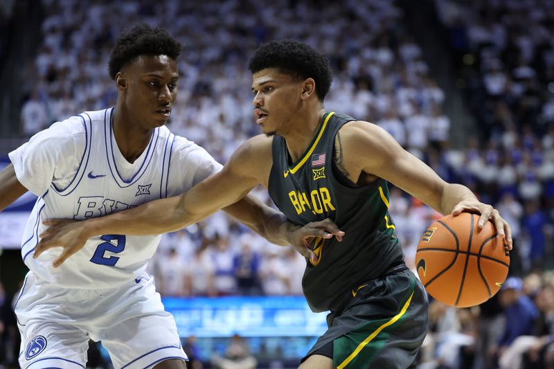 Feb 20, 2024; Provo, Utah, USA; Baylor Bears guard RayJ Dennis (10) drives against Brigham Young Cougars guard Jaxson Robinson (2) during the first half at Marriott Center. Mandatory Credit: Rob Gray-USA TODAY Sports