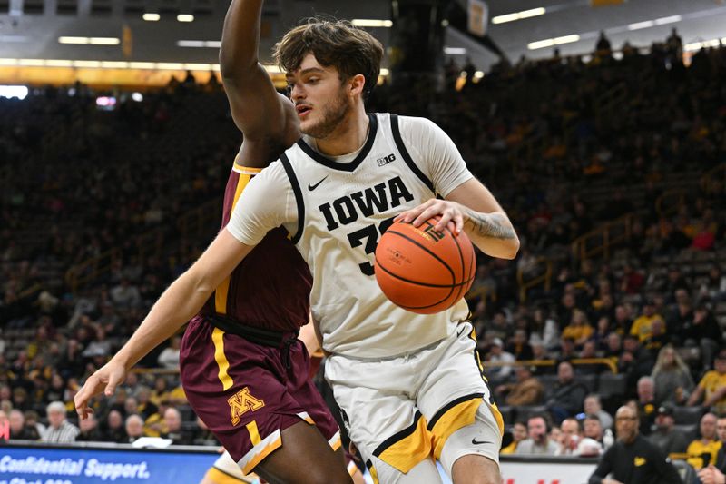 Feb 11, 2024; Iowa City, Iowa, USA; Iowa Hawkeyes forward Owen Freeman (32) goes to the basket as Minnesota Golden Gophers forward Pharrel Payne (21) defends during the second half at Carver-Hawkeye Arena. Mandatory Credit: Jeffrey Becker-USA TODAY Sports