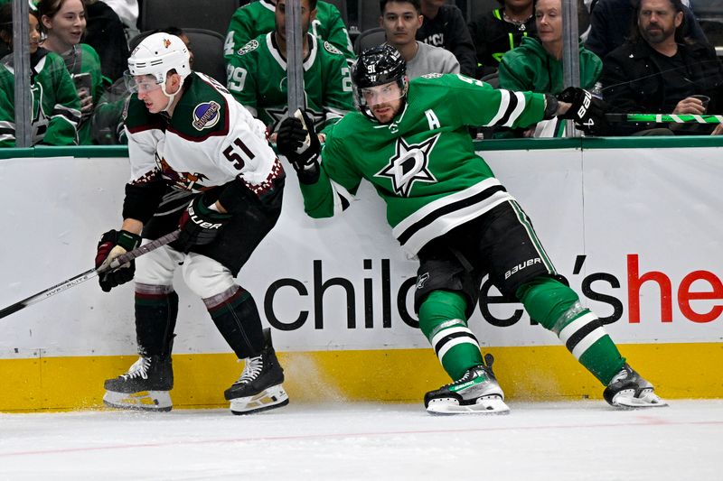 Nov 14, 2023; Dallas, Texas, USA; Arizona Coyotes defenseman Troy Stecher (51) avoids the check by Dallas Stars center Tyler Seguin (91) during the third period at the American Airlines Center. Mandatory Credit: Jerome Miron-USA TODAY Sports