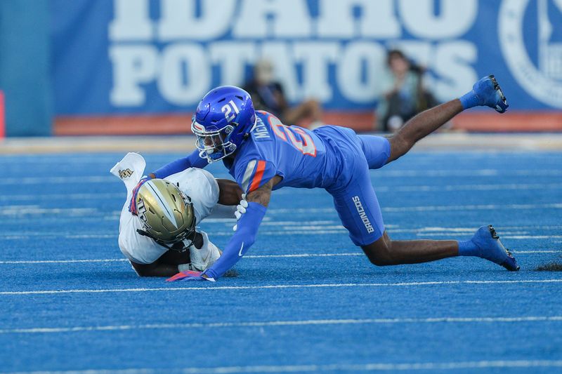 Sep 9, 2023; Boise, Idaho, USA; UCF Knights wide receiver Kobe Hudson (2) is tackled by Boise State Broncos cornerback A'Marion McCoy (21) during the second half of play at Albertsons Stadium. UCF beats Boise State 18-16. Mandatory Credit: Brian Losness-USA TODAY Sports
