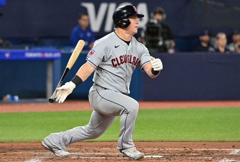 Aug 26, 2023; Toronto, Ontario, CAN;  Cleveland Guardians first baseman Kole Calhoun (56) hits a single against the Toronto Blue Jays in the sixth inning at Rogers Centre. Mandatory Credit: Dan Hamilton-USA TODAY Sports