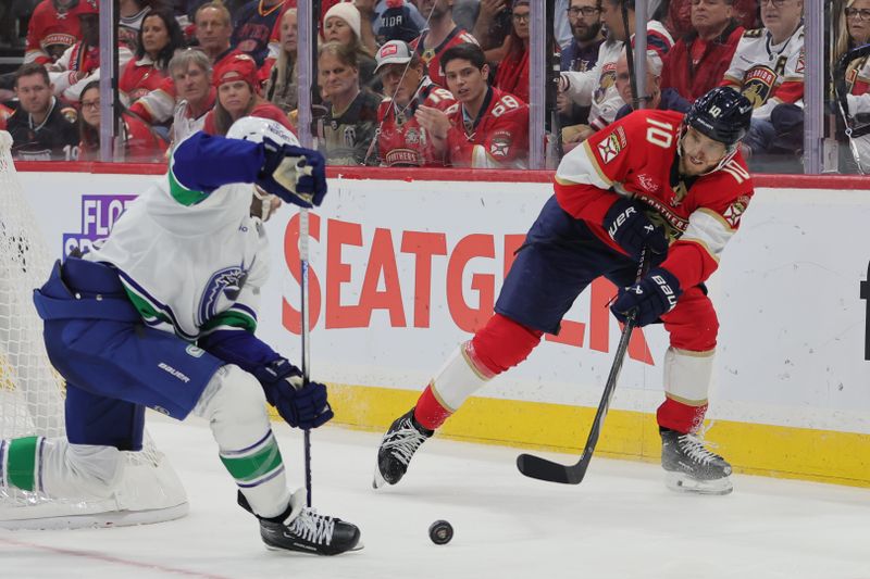 Oct 17, 2024; Sunrise, Florida, USA; Florida Panthers left wing A.J. Greer (10) moves the puck against the Vancouver Canucks during the third period at Amerant Bank Arena. Mandatory Credit: Sam Navarro-Imagn Images