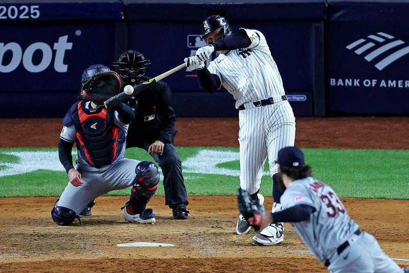 Oct 15, 2024; Bronx, New York, USA; New York Yankees outfielder Aaron Judge (99) hits a two run home run during the seventh inning against the Cleveland Guardians in game two of the ALCS for the 2024 MLB Playoffs at Yankee Stadium. Mandatory Credit: Brad Penner-Imagn Images