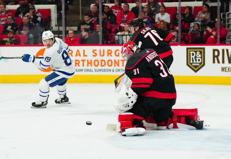 Mar 24, 2024; Raleigh, North Carolina, USA;  Carolina Hurricanes goaltender Frederik Andersen (31) stops the shot in front of Toronto Maple Leafs left wing Nicholas Robertson (89) during the second period at PNC Arena. Mandatory Credit: James Guillory-USA TODAY Sports