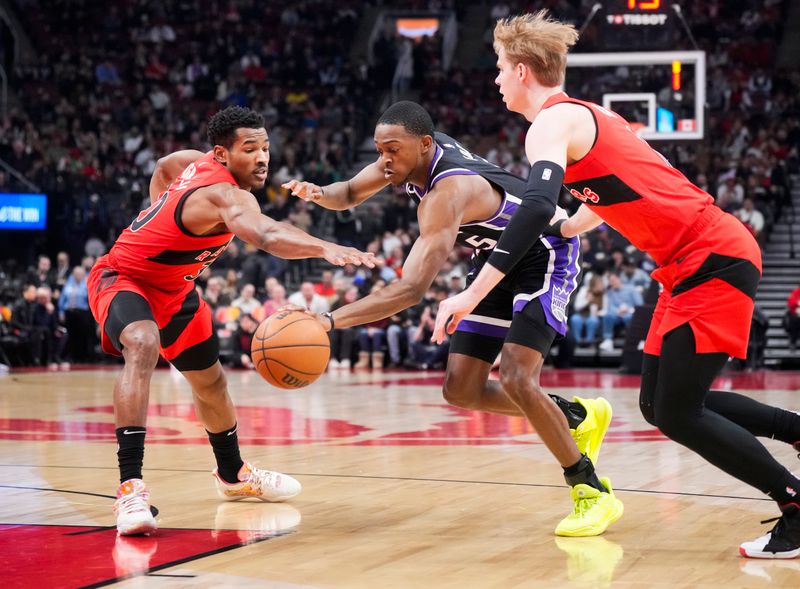 TORONTO, ON - MARCH 20: De'Aaron Fox #5 of the Sacramento Kings drives against Ochai Agbaji #30 and Gradey Dick #1 of the Toronto Raptors during the first half at the Scotiabank Arena on March 20, 2024 in Toronto, Ontario, Canada. NOTE TO USER: User expressly acknowledges and agrees that, by downloading and/or using this Photograph, user is consenting to the terms and conditions of the Getty Images License Agreement. (Photo by Mark Blinch/Getty Images)