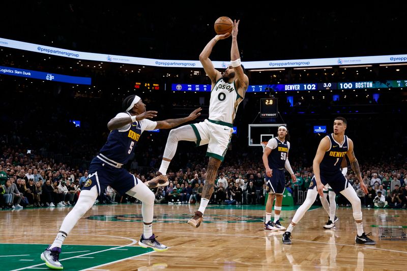 BOSTON, MA - JANUARY 19: Jayson Tatum #0 of the Boston Celtics takes a shot with 2.8 seconds left to tie the game but missed as Kentavious Caldwell-Pope #5 of the Denver Nuggets defends during the second half at TD Garden on January 19, 2024 in Boston, Massachusetts. NOTE TO USER: User expressly acknowledges and agrees that, by downloading and/or using this Photograph, user is consenting to the terms and conditions of the Getty Images License Agreement. (Photo By Winslow Townson/Getty Images)