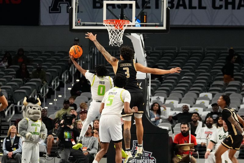 Mar 16, 2024; Fort Worth, TX, USA;  South Florida Bulls guard Jayden Reid (0) scores a layup against UAB Blazers forward Yaxel Lendeborg (3) during the second half at Dickies Arena. Mandatory Credit: Chris Jones-USA TODAY Sports