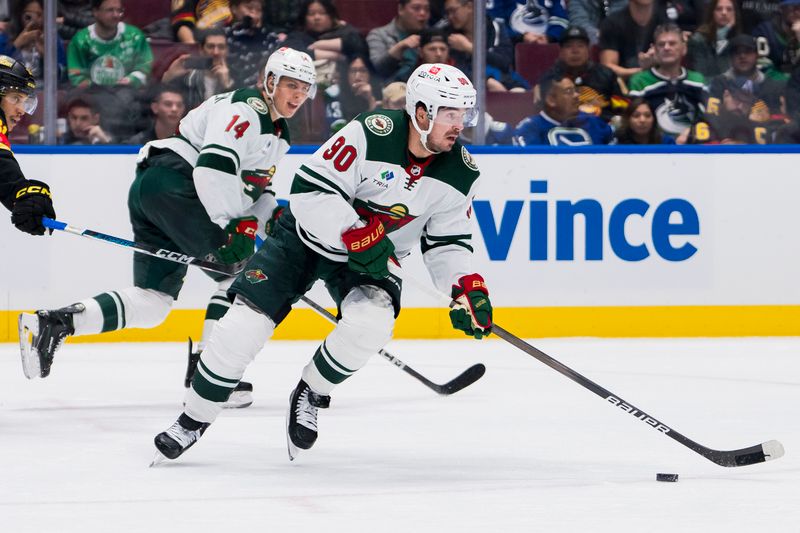 Dec 7, 2023; Vancouver, British Columbia, CAN; Minnesota Wild forward Marcus Johansson (90) handles the puck  against the Vancouver Canucks in the third period at Rogers Arena. Vancouver won 2-0. Mandatory Credit: Bob Frid-USA TODAY Sports