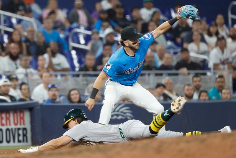 May 4, 2025; Miami, Florida, USA;  Oakland Athletics first baseman Nick Kurtz (16) slides into third base on his triple against the Miami Marlins during the ninth inning at loanDepot Park. Mandatory Credit: Rhona Wise-Imagn Images