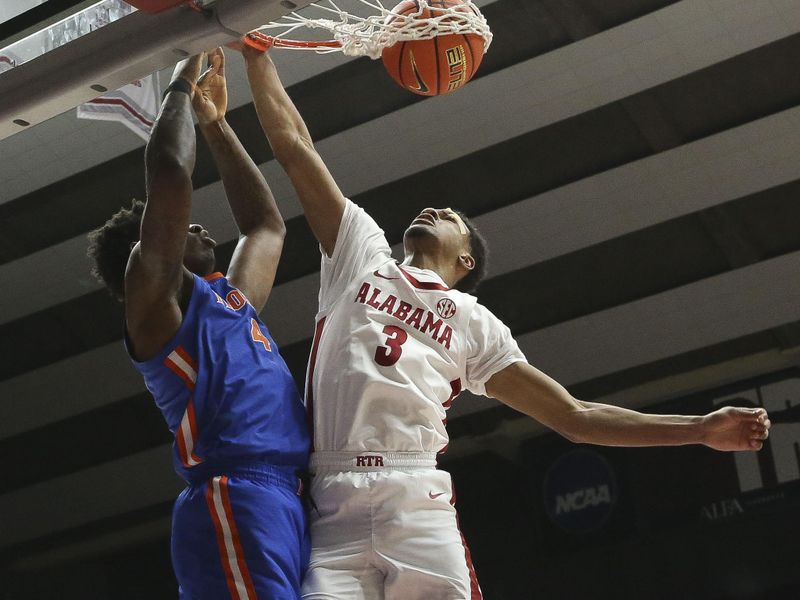 Feb 21, 2024; Tuscaloosa, Alabama, USA;  Florida Gators forward Tyrese Samuel (4) dunks the ball over Alabama Crimson Tide guard Rylan Griffen (3) at Coleman Coliseum. Mandatory Credit: Gary Cosby Jr.-USA TODAY Sports