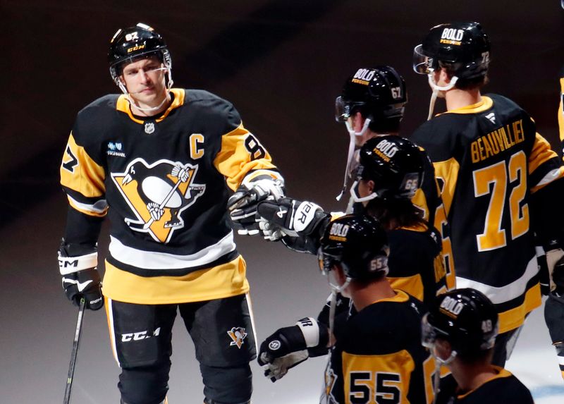 Oct 9, 2024; Pittsburgh, Pennsylvania, USA;  Pittsburgh Penguins center Sidney Crosby (87) greets teammates during player introductions against the New York Rangers at PPG Paints Arena. Mandatory Credit: Charles LeClaire-Imagn Images