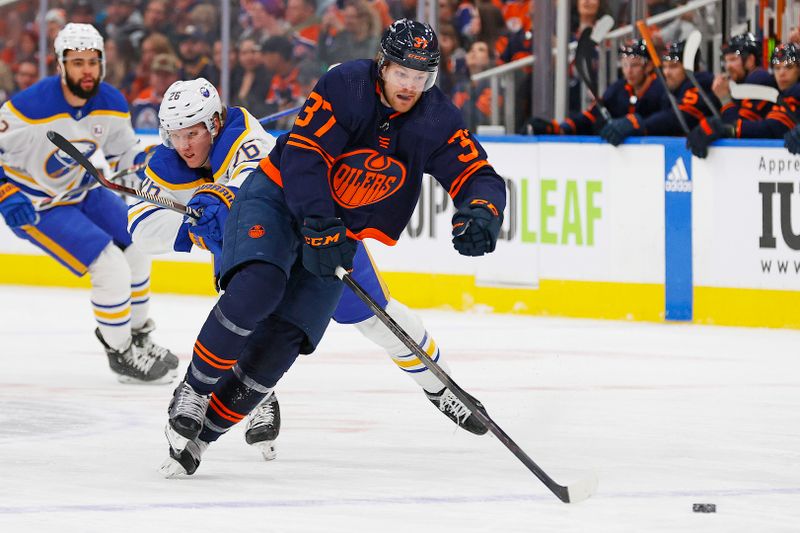 Mar 21, 2024; Edmonton, Alberta, CAN; Buffalo Sabres defensemen Rasmus Dahlin (26) tries to check Edmonton Oilers forward Warren Foegele (37) during the first period at Rogers Place. Mandatory Credit: Perry Nelson-USA TODAY Sports