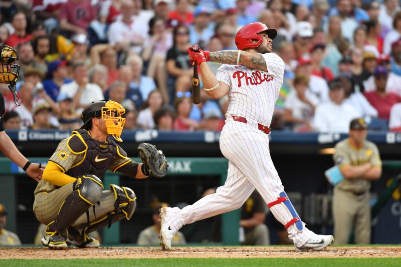 Jun 17, 2024; Philadelphia, Pennsylvania, USA; Philadelphia Phillies catcher Rafael Marchán (13) hits an RBI single during the fourth inning against the San Diego Padres at Citizens Bank Park. Mandatory Credit: Eric Hartline-USA TODAY Sports