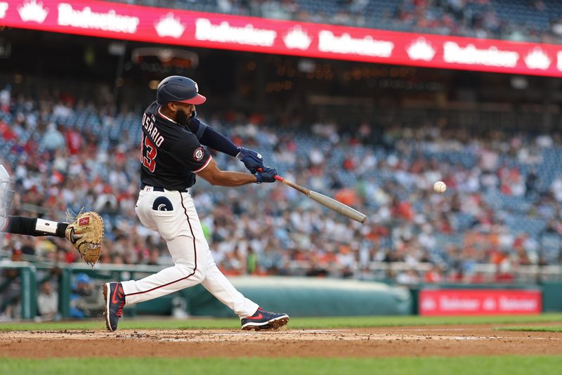 Apr 24, 2025; Washington, District of Columbia, USA; Washington Nationals third base Amed Rosario (13) doubles against the Baltimore Orioles during the second inning at Nationals Park. Mandatory Credit: Geoff Burke-Imagn Images