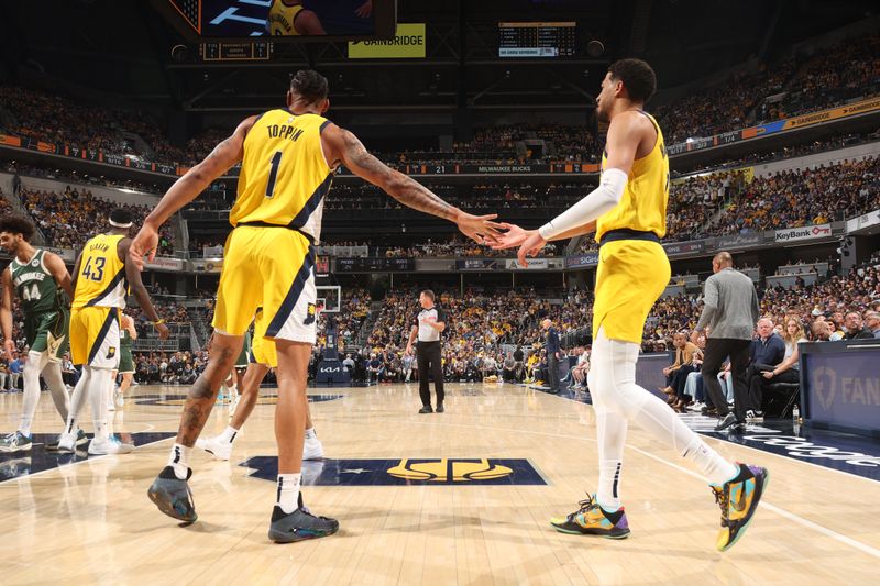 INDIANAPOLIS, IN - APRIL 28: Obi Toppin #1  high fives  Tyrese Haliburton #0 of the Indiana Pacers during the game against the Milwaukee Bucks during Round 1 Game 4 of the 2024 NBA Playoffs on April 28, 2024 at Gainbridge Fieldhouse in Indianapolis, Indiana. NOTE TO USER: User expressly acknowledges and agrees that, by downloading and or using this Photograph, user is consenting to the terms and conditions of the Getty Images License Agreement. Mandatory Copyright Notice: Copyright 2024 NBAE (Photo by Nathaniel S. Butler/NBAE via Getty Images)