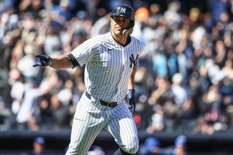 Apr 7, 2024; Bronx, New York, USA; New York Yankees designated hitter Giancarlo Stanton (27) gestures to the dugout after hitting a grand slam home run in the third inning against the Toronto Blue Jays at Yankee Stadium. Mandatory Credit: Wendell Cruz-USA TODAY Sports