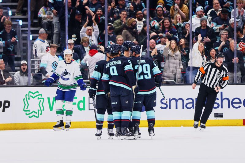 Feb 28, 2026; Seattle, Washington, USA; The Seattle Kraken celebrate a goal scored by Seattle Kraken center Chandler Stephenson (9) during the first period against the Vancouver Canucks at Climate Pledge Arena. Mandatory Credit: Blake Dahlin-Imagn Images