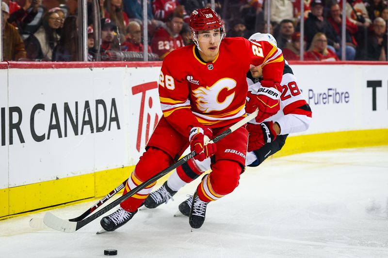 Jan 19, 2026; Calgary, Alberta, CAN; Calgary Flames defenseman Zach Whitecloud (28) controls the puck against New Jersey Devils right wing Timo Meier (28) during the first period at Scotiabank Saddledome. Mandatory Credit: Sergei Belski-Imagn Images