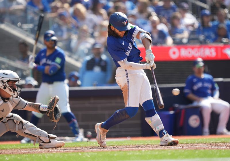 May 20, 2024; Toronto, Ontario, CAN; Toronto Blue Jays shortstop Bo Bichette (11) hits an RBI double against the Chicago White Sox during the sixth inning at Rogers Centre. Mandatory Credit: Nick Turchiaro-USA TODAY Sports