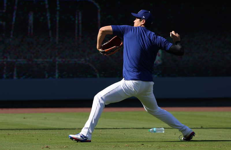 Jun 2, 2025; Los Angeles, California, USA; Los Angeles Dodgers designated hitter Shohei Ohtani (17) warms up before a game against the New York Mets at Dodger Stadium. Mandatory Credit: Jason Parkhurst-Imagn Images