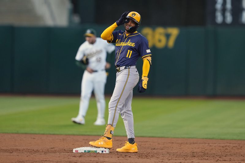 Aug 23, 2024; Oakland, California, USA; Milwaukee Brewers left fielder Jackson Chourio (11) gestures after hitting an RBI-single against the Oakland Athletics during the second inning at Oakland-Alameda County Coliseum. Mandatory Credit: Darren Yamashita-USA TODAY Sports