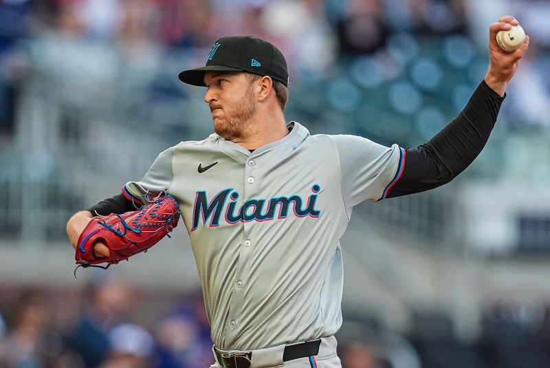 Apr 23, 2024; Cumberland, Georgia, USA; Miami Marlins pitcher Trevor Rogers (28) pitches against the Atlanta Braves during the first inning at Truist Park. Mandatory Credit: Dale Zanine-USA TODAY Sports