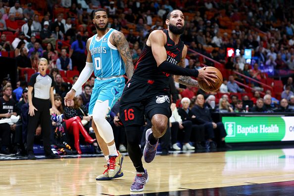 MIAMI, FLORIDA - DECEMBER 13: Caleb Martin #16 of the Miami Heat drives to the basket against the Charlotte Hornets during the first quarter of the game at Kaseya Center on December 13, 2023 in Miami, Florida. NOTE TO USER: User expressly acknowledges and agrees that, by downloading and or using this photograph, User is consenting to the terms and conditions of the Getty Images License Agreement. (Photo by Megan Briggs/Getty Images)