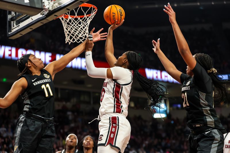 Jan 28, 2024; Columbia, South Carolina, USA; South Carolina Gamecocks forward Sania Feagin (20) shoots over Vanderbilt Commodores guard Jordyn Oliver (11) and guard Iyana Moore (23) in the first half at Colonial Life Arena. Mandatory Credit: Jeff Blake-USA TODAY Sports