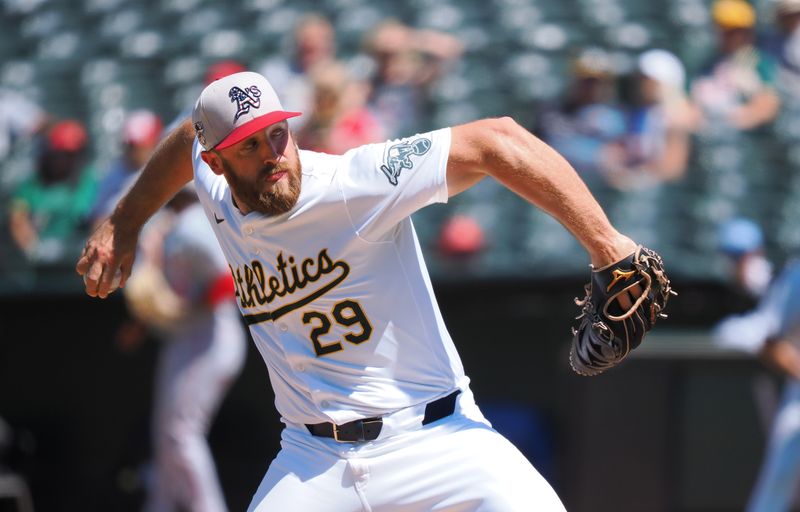 Jul 4, 2024; Oakland, California, USA; Oakland Athletics relief pitcher Austin Adams (29) pitches the ball against the Los Angeles Angels during the seventh inning at Oakland-Alameda County Coliseum. Mandatory Credit: Kelley L Cox-USA TODAY Sports