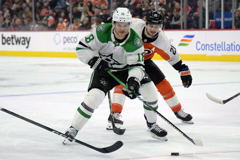 Jan 18, 2024; Philadelphia, Pennsylvania, USA;  Dallas Stars center Sam Steel (18) and Philadelphia Flyers center Scott Laughton (21) battle for the puck during the second period at Wells Fargo Center. Mandatory Credit: Eric Hartline-USA TODAY Sports