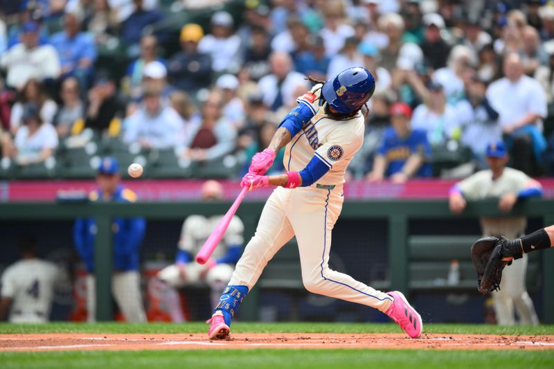 May 11, 2025; Seattle, Washington, USA; Seattle Mariners shortstop J.P. Crawford (3) hits a double against the Toronto Blue Jays during the first inning at T-Mobile Park. Mandatory Credit: Steven Bisig-Imagn Images