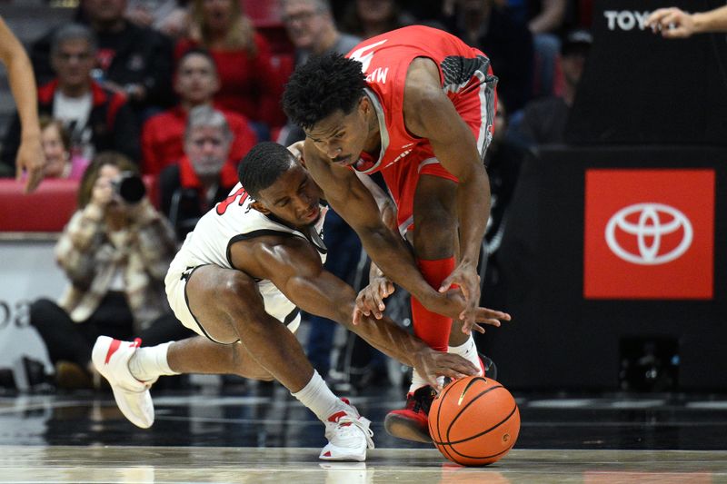 Jan 14, 2023; San Diego, California, USA; New Mexico Lobos guard Jamal Mashburn Jr. (5) and San Diego State Aztecs guard Lamont Butler (5) battle for a loose ball during the second half at Viejas Arena. Mandatory Credit: Orlando Ramirez-USA TODAY Sports