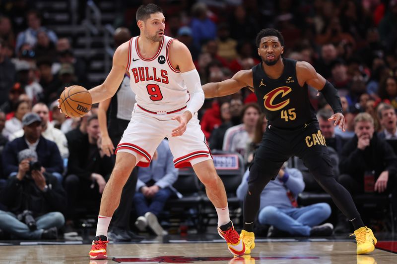 CHICAGO, ILLINOIS - FEBRUARY 28: Nikola Vucevic #9 of the Chicago Bulls is defended by Donovan Mitchell #45 of the Cleveland Cavaliers during the first half at the United Center on February 28, 2024 in Chicago, Illinois. NOTE TO USER: User expressly acknowledges and agrees that, by downloading and or using this photograph, User is consenting to the terms and conditions of the Getty Images License Agreement. (Photo by Michael Reaves/Getty Images)