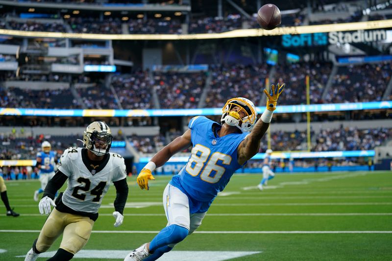 Los Angeles Chargers wide receiver Keelan Doss (86) can't reach a pass in the end zone as New Orleans Saints safety Johnathan Abram (24) covers in the first half of an NFL football game in Inglewood, Calif., Sunday, Aug. 20, 2023. (AP Photo/Marcio Jose Sanchez)